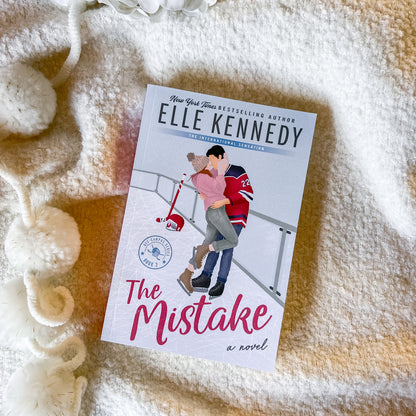 Book titled 'The Mistake' by Elle Kennedy on a textured surface