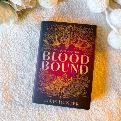 Book titled 'Blood Bound' by Ellis Hunter on a textured surface with flowers in the background
