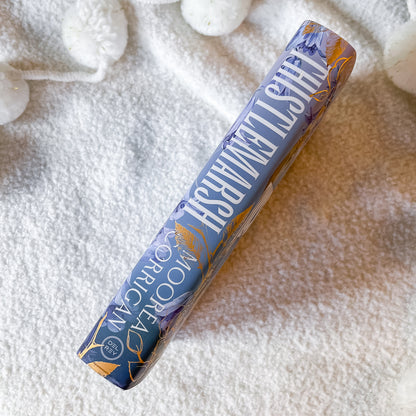 spine of book called "thistlemarsh" on a textured white surface