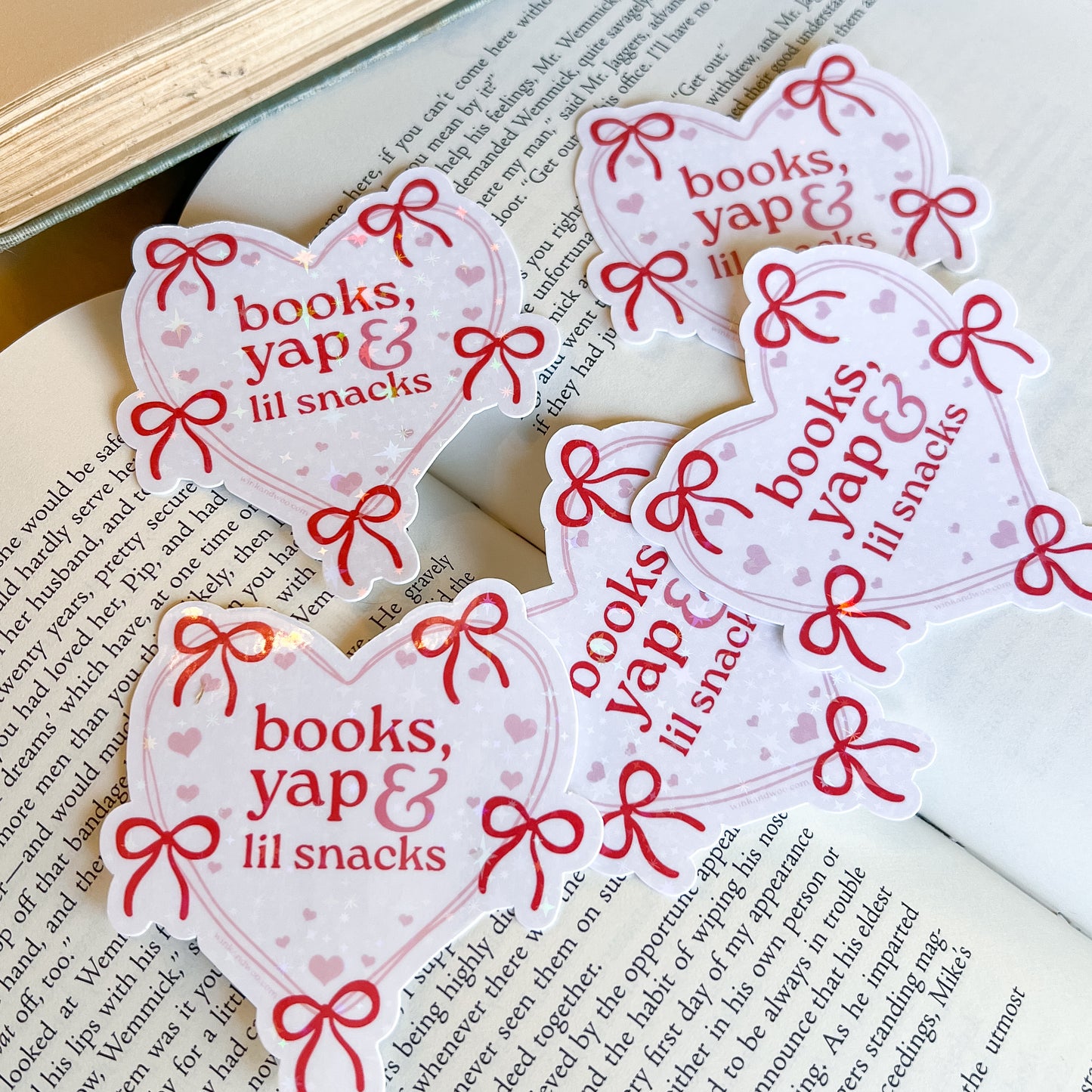 Heart-shaped stickers with 'books, yap & lil snacks' text on a book page.