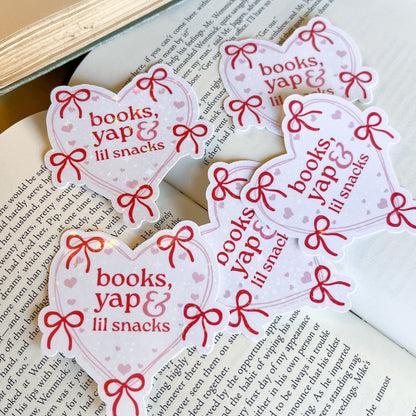 Heart-shaped stickers with 'books, yap & lil snacks' text on a book page.