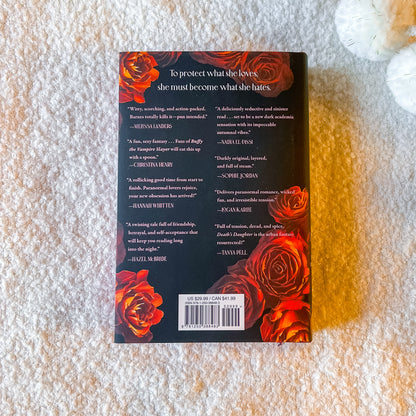 Back cover of 'Death's Daughter' with roses and a gravestone design on a white background