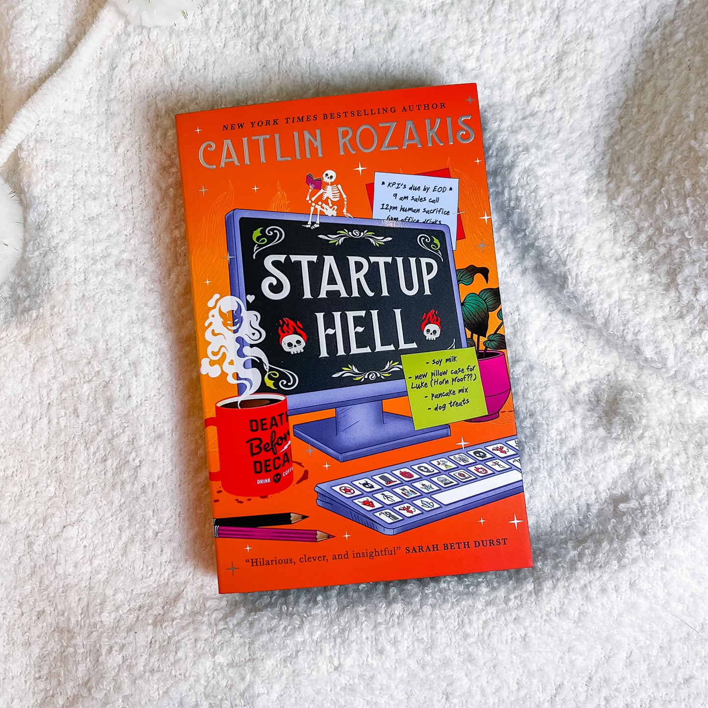 Book titled 'Startup Hell' by Caitlin Rozakis on a textured white surface
