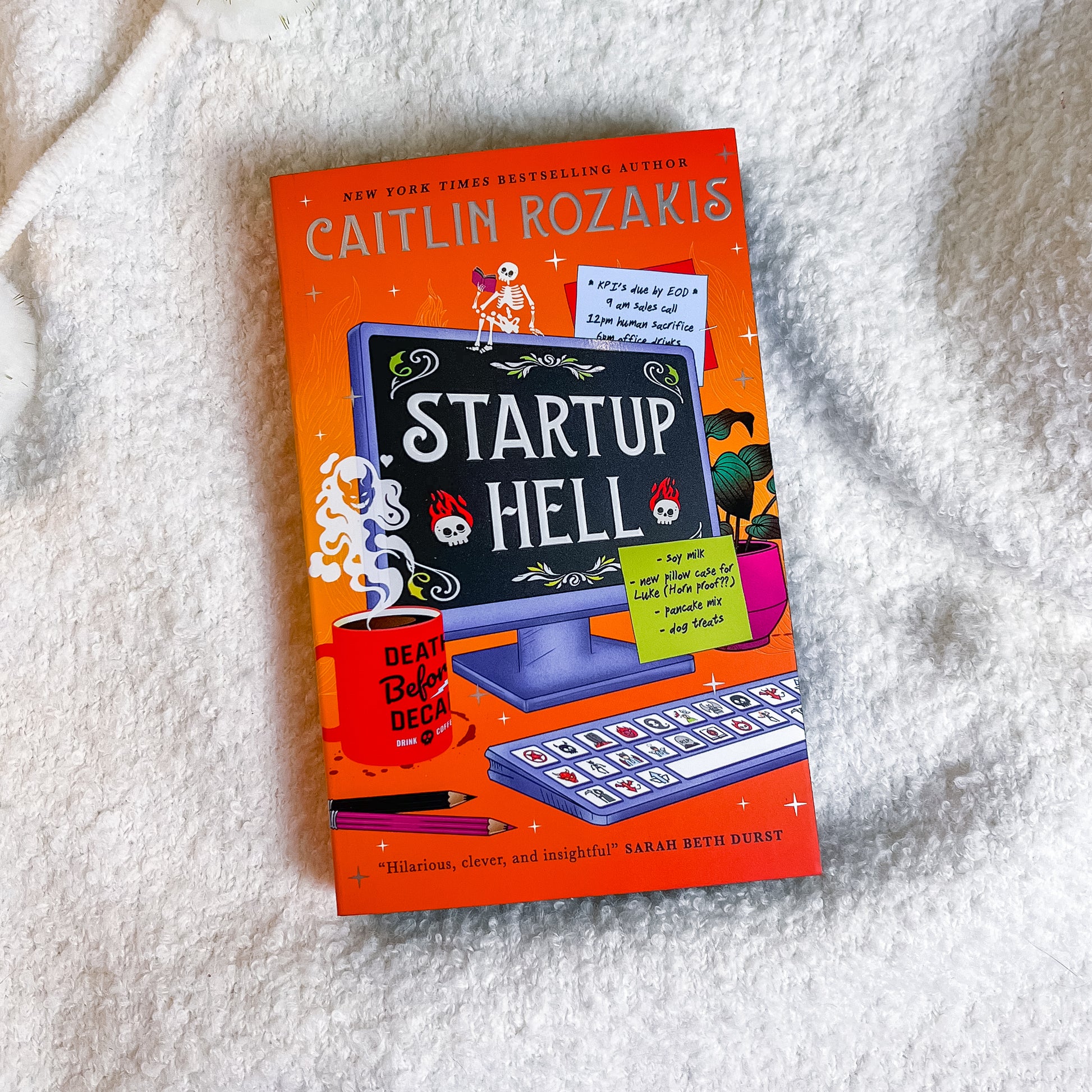Book titled 'Startup Hell' by Caitlin Rozakis on a textured white surface
