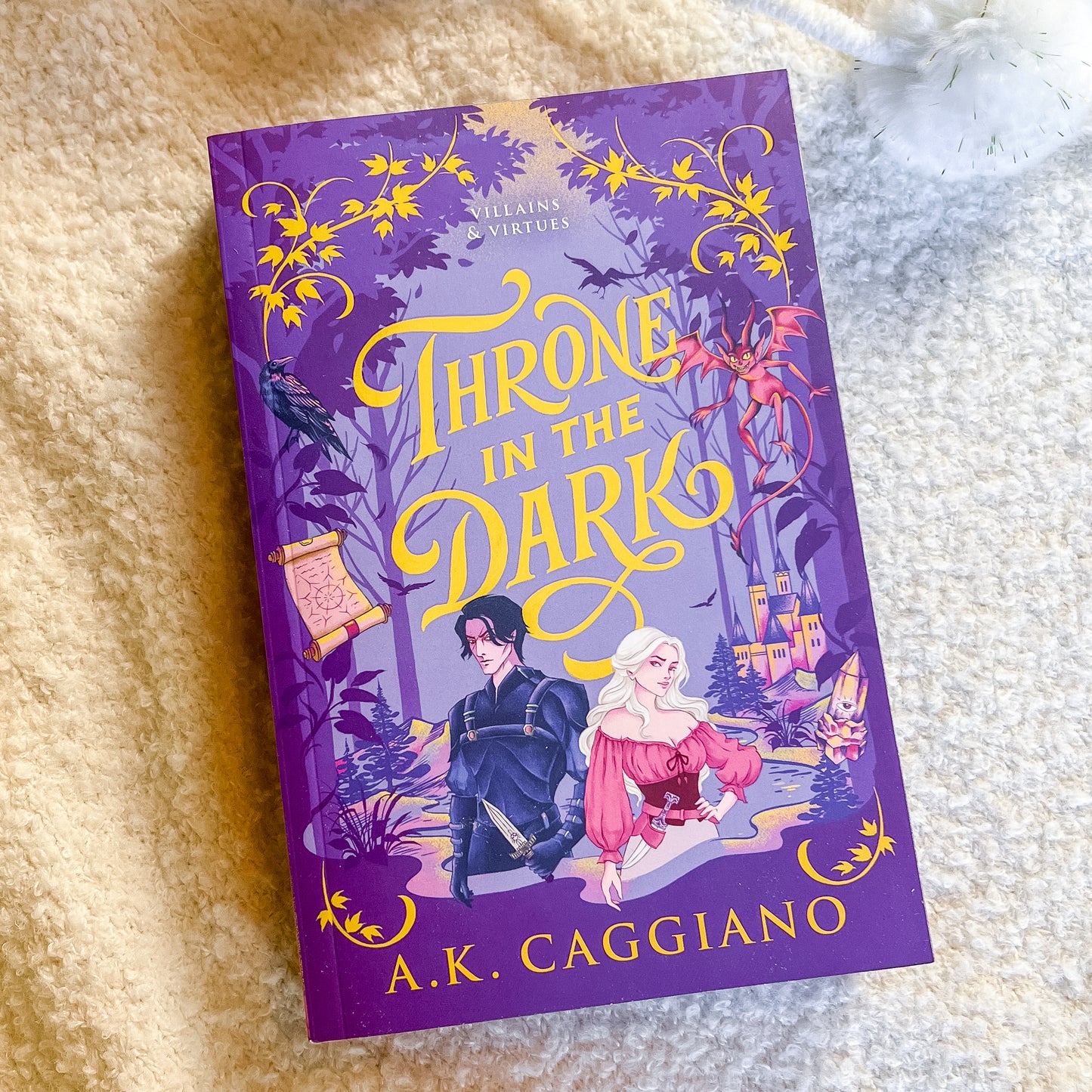 Book titled 'Throne in the Dark' by A.K. Caggiano on a textured surface
