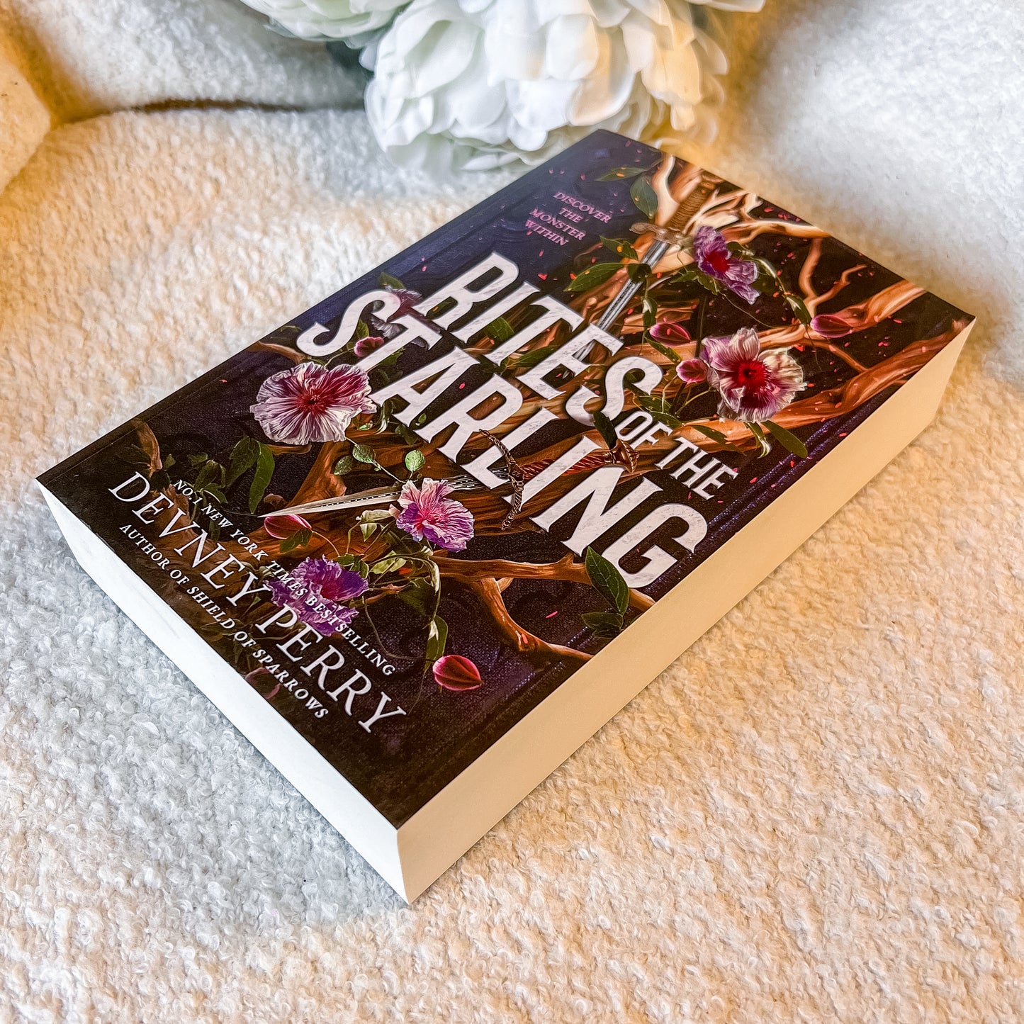 A book "Rites of the Starling" on a textured white surface.