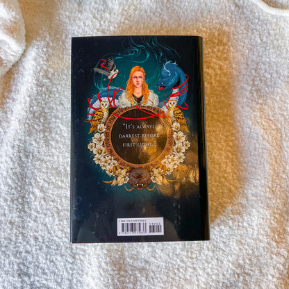 Book cover with a woman's face and decorative elements on a textured surface