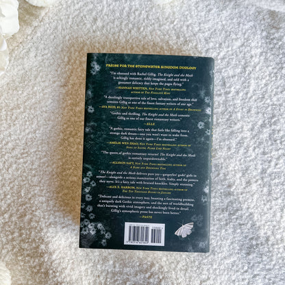The back cover of a book, photographed flat on a textured white fabric background.