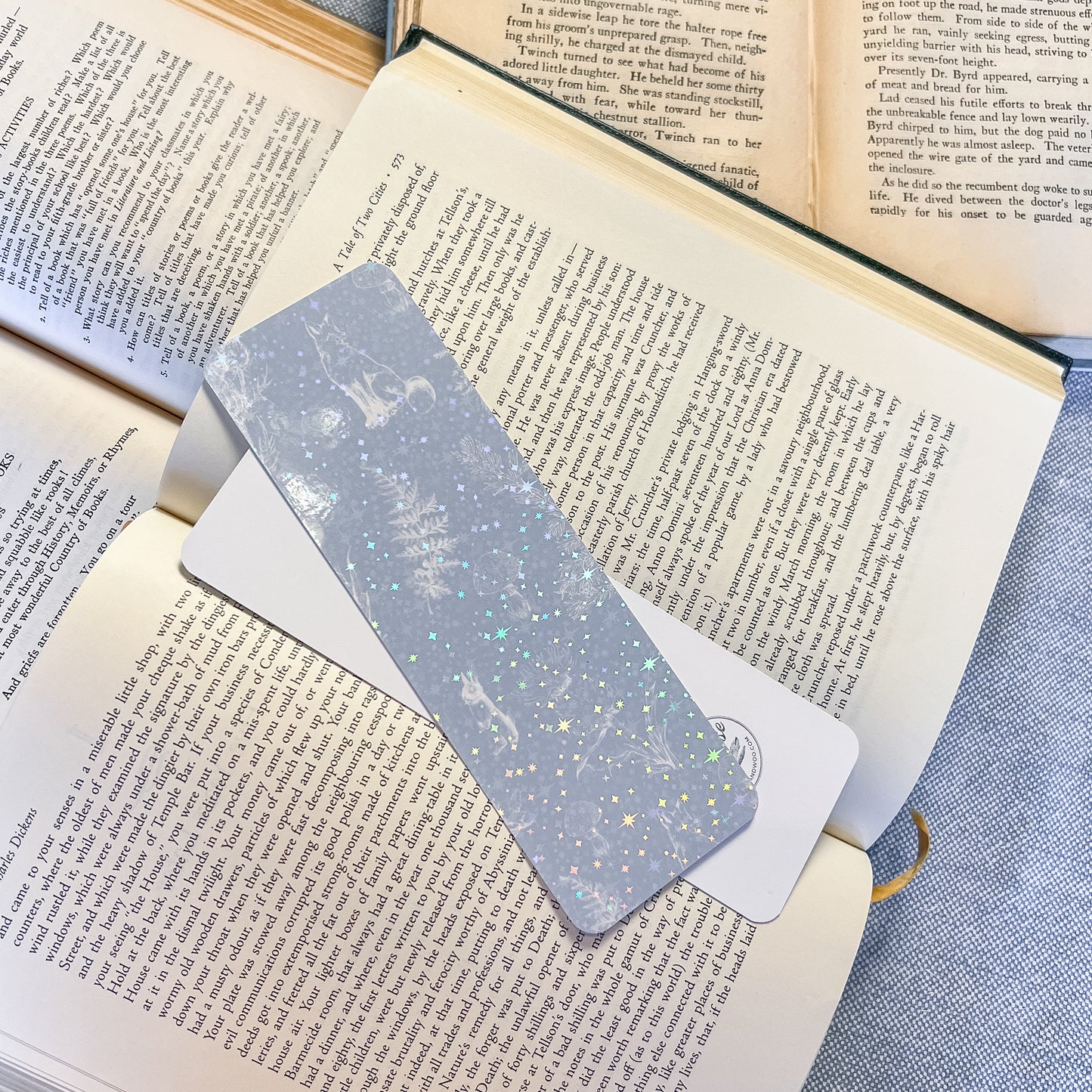 Metallic bookmark on an open book with a blue fabric background