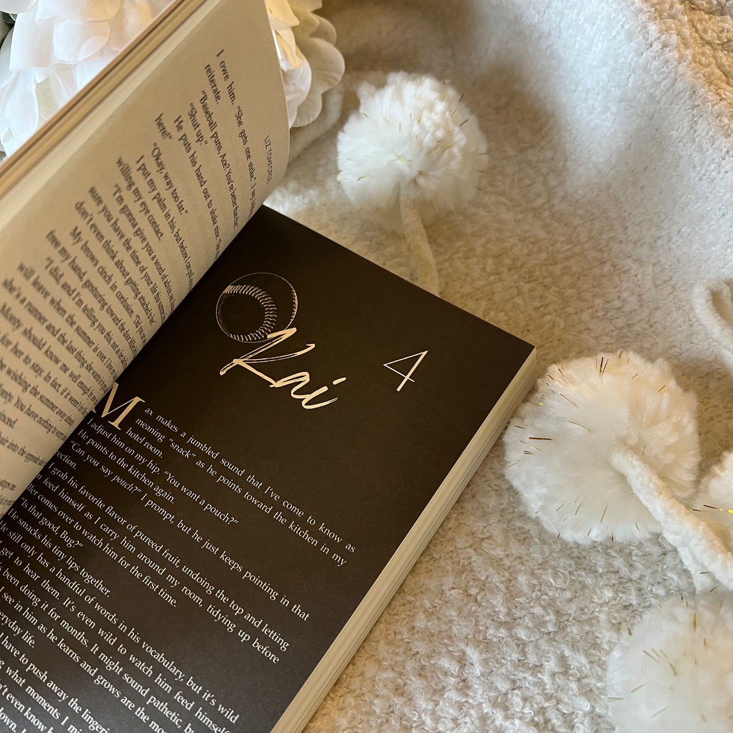 Open book with decorative name card on a soft surface