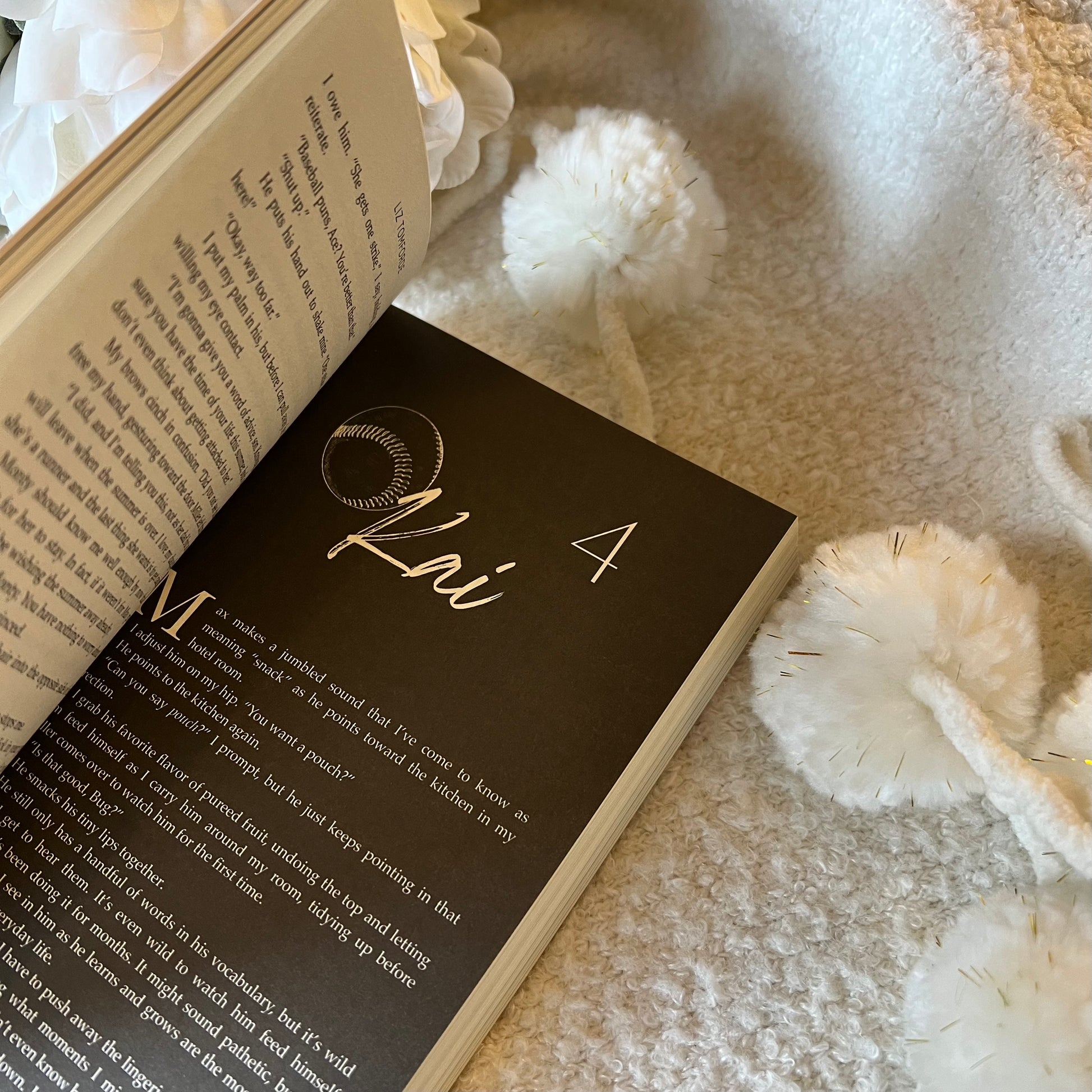 Open book with decorative name card on a soft surface