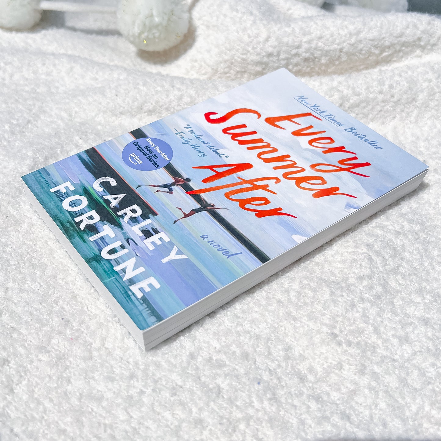 Book titled 'Every Summer After' by Carley Fortune on a textured white surface
