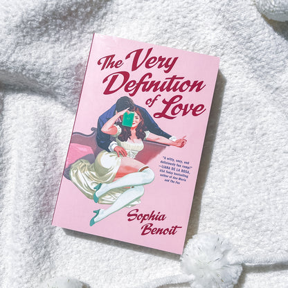A book, "the very definition of love" by Sophie Benoit, showing a couple embracing on the cover.
