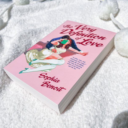 A book, "the very definition of love" by Sophie Benoit, showing a couple embracing on the cover.