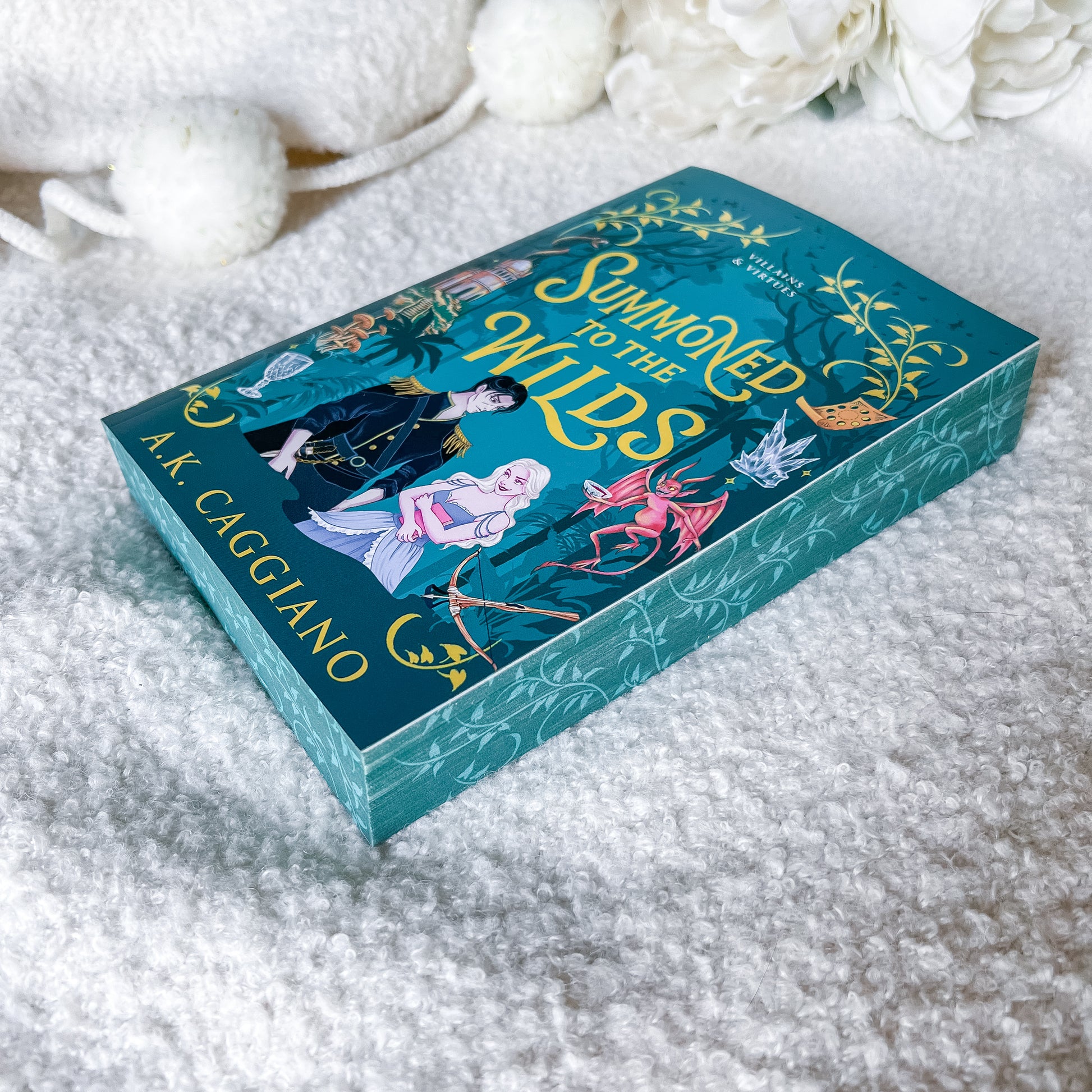 A boxed book titled "Summoned to the Wilds" by A.K.