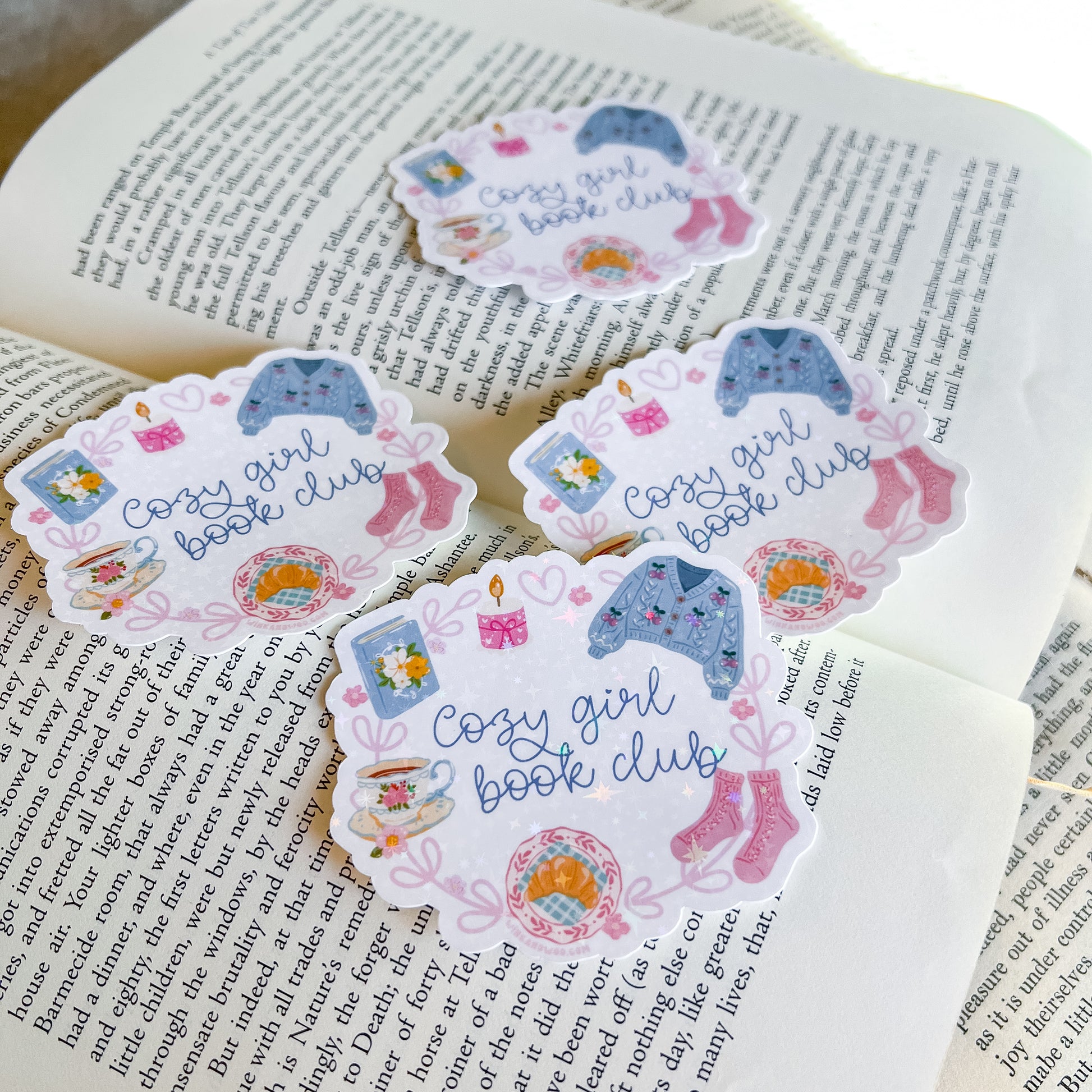 Cozy Girl Book Club stickers on an open book