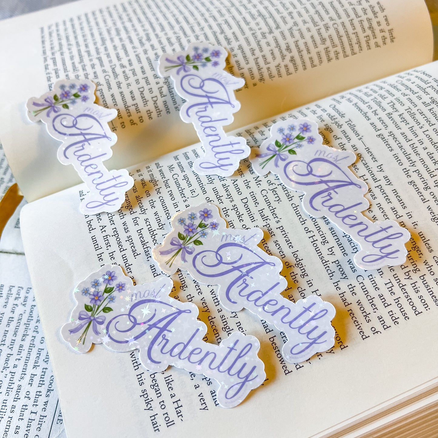 Decorative stickers with the word 'Ardently' on an open book