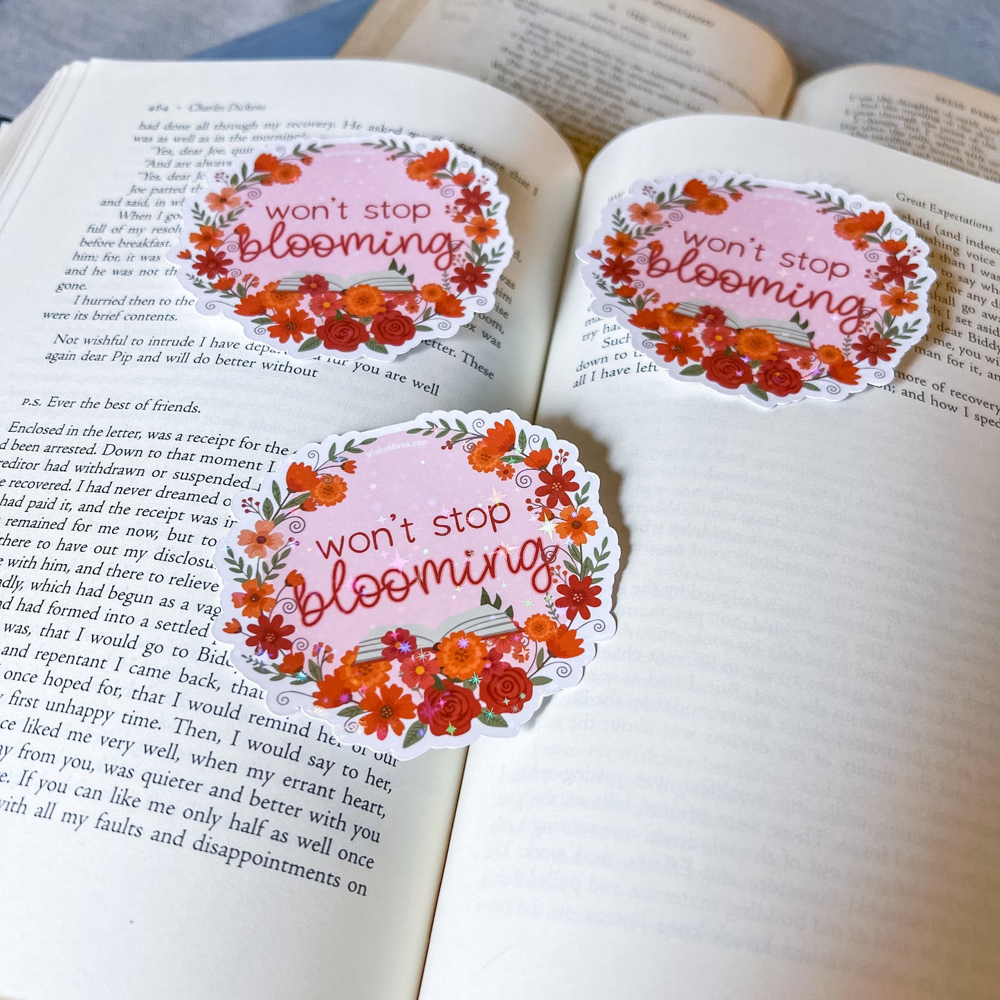 Floral stickers with 'won't stop blooming' text on an open book