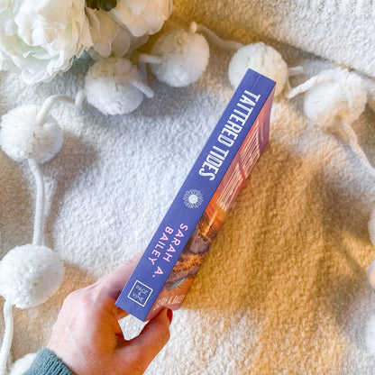The spine of book "tattered tides" by Sarah A. Bailey