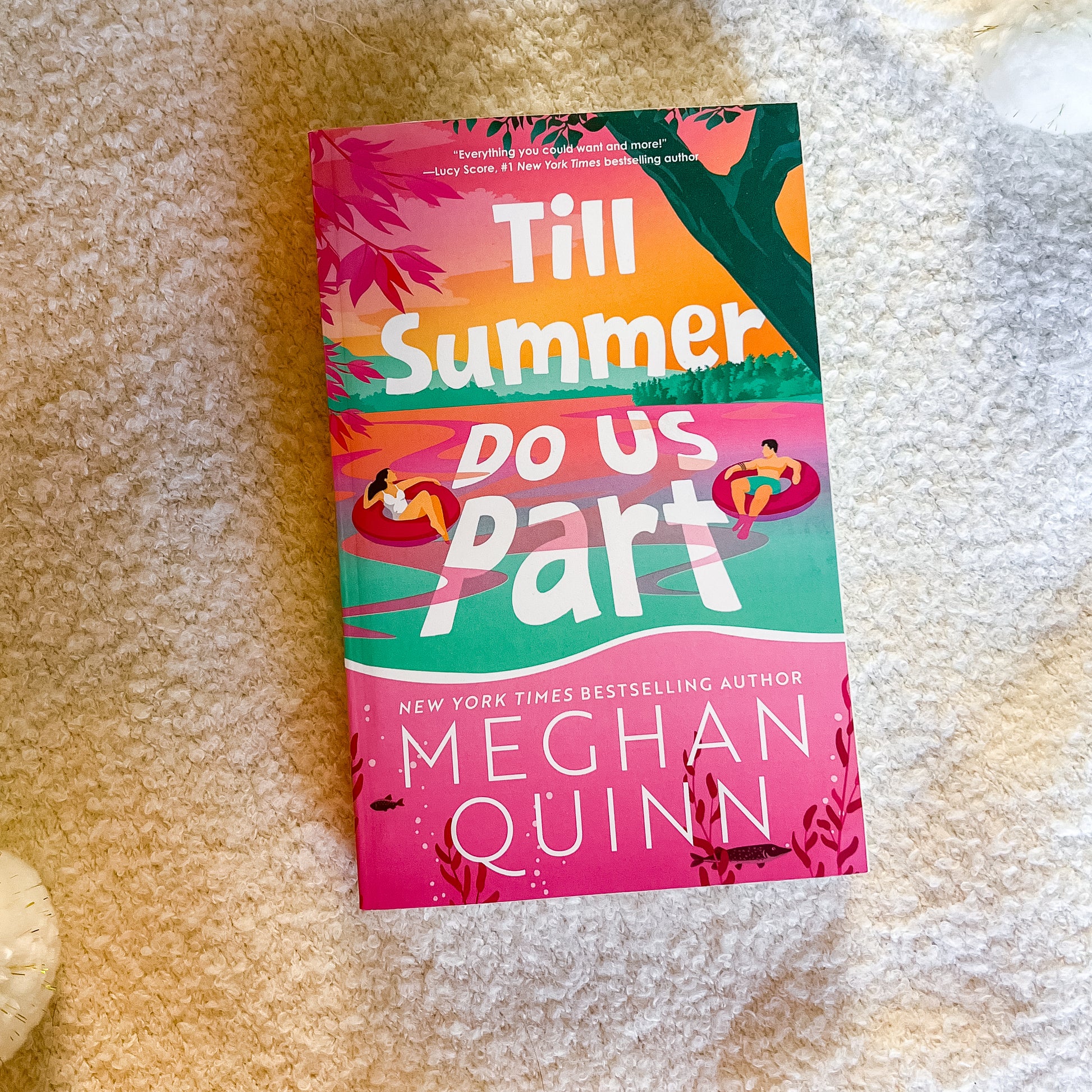 Book titled 'Till Summer Do Us Part' by Meghan Quinn on a textured surface