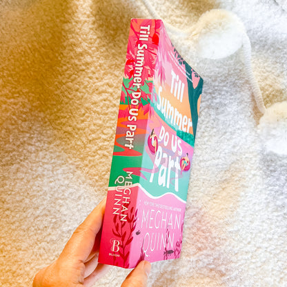 Book titled 'Till Summer Do Us Part' by Meaghan Quinn held against a textured beige background.