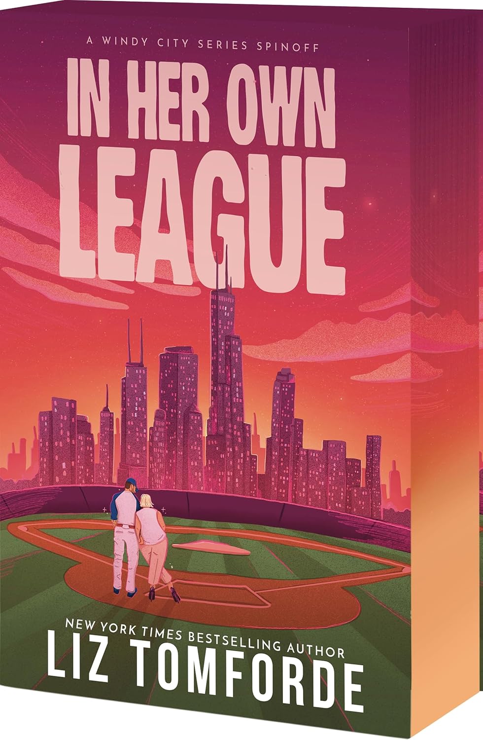 Book cover of 'In Her Own League' by Liz Tomforde with a city skyline and baseball field illustration.