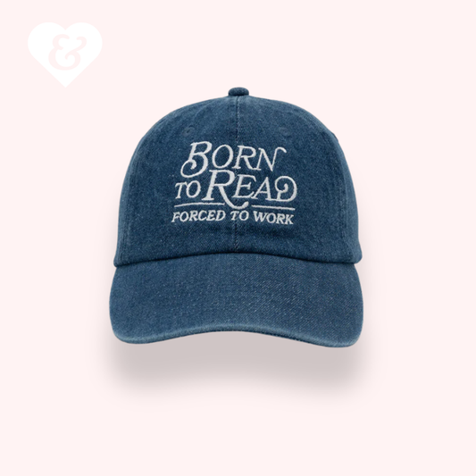 Blue cap with 'Born to Read, Forced to Work' text on a white background