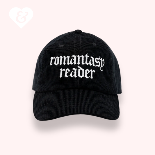Black cap with 'romantasy reader' text on a white background