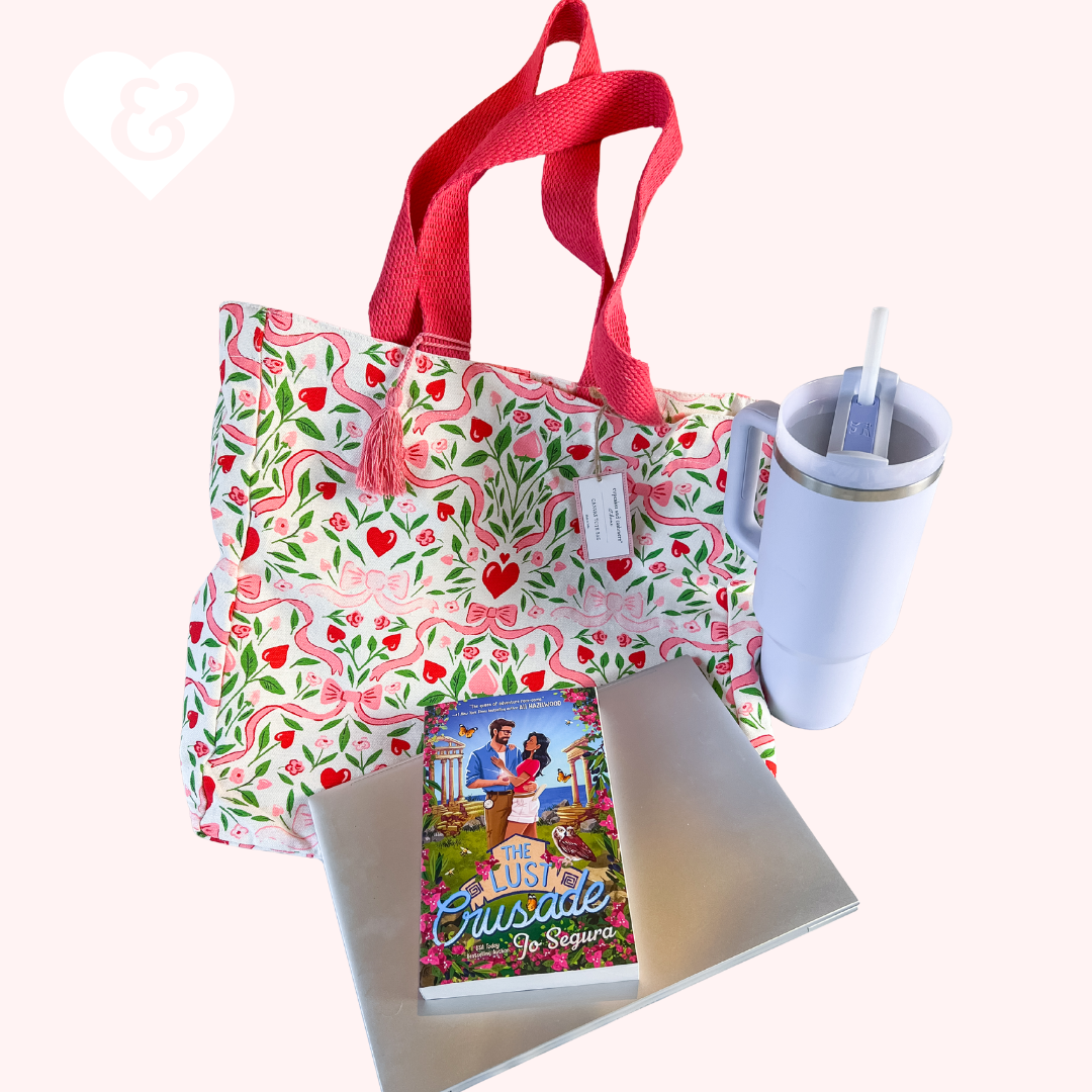 Floral tote bag with red handles, mug, book, and notebook on a white background