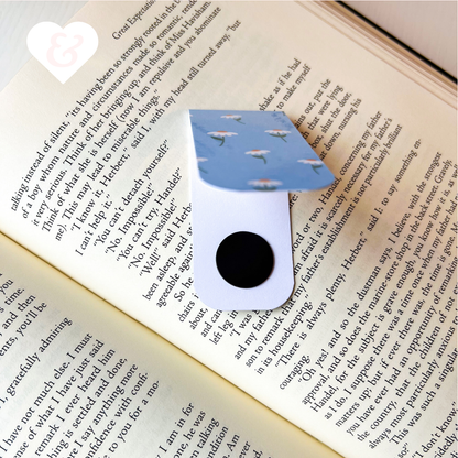 Blue and white bookmark with cloud pattern on an open book