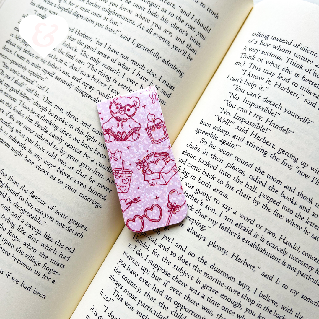 Pink bookmark with heart designs on an open book