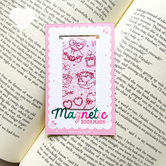 Pink magnetic bookmark with cartoon design on an open book