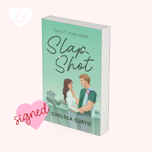 Book titled 'Slap Shot' by Chelsea Curto with a heart-shaped sign indicating it is signed.