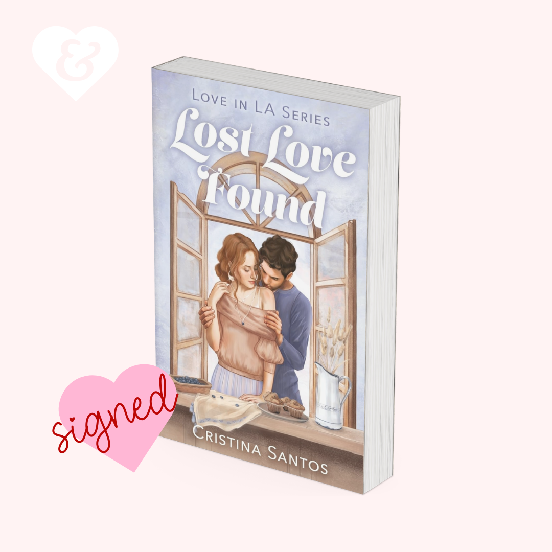 Book titled 'Lost Love Found' by Cristina Santos with a couple embracing in front of a window on the cover.