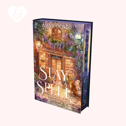 Book cover of 'Stay for a Spell' by Amy Coombe with a cozy street scene illustration.