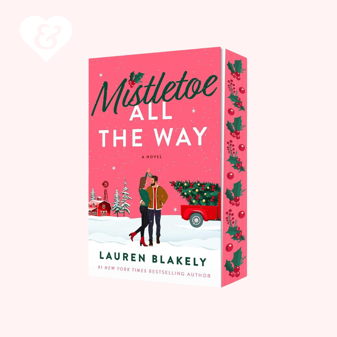 Book cover of 'Mistletoe All The Way' by Lauren Blakely with a pink background and Christmas-themed illustrations.