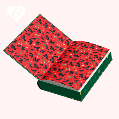 book with red and green pattern of black birds on a white background