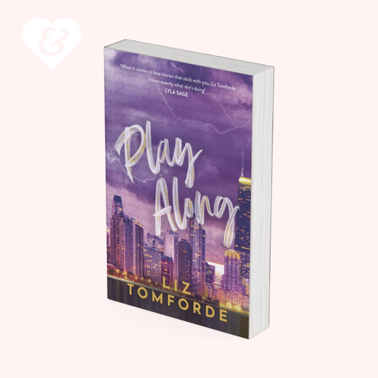Book titled 'Play Along' by Liz Tomforde with a cityscape design on the cover.