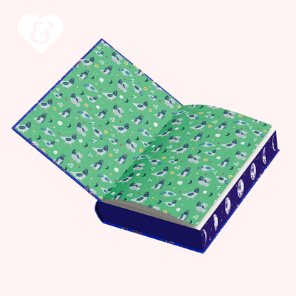 Open book with a green end papers featuring pigeon pattern on a white background