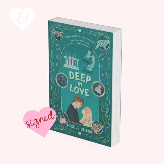 A book cover for 'Deep in Love' by Nicole Cubba, featuring a teal and gold illustration with a couple, a microscope, and scientific motifs, shown on a pale pink background with a pink 'signed' heart graphic and a white ampersand heart icon.