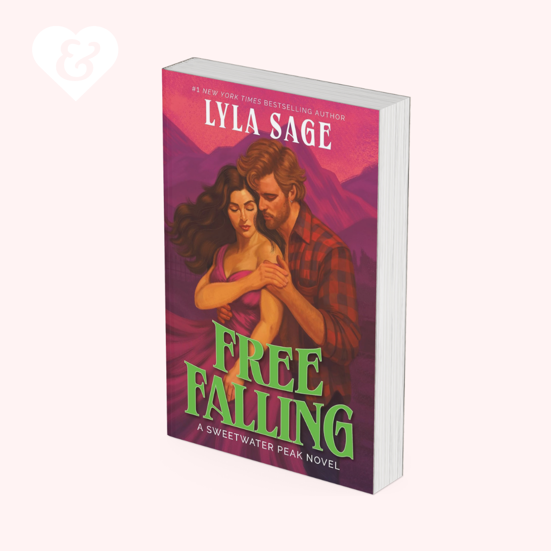 A 3D mockup of the book cover for 'Free Falling' by Lyla Sage, showing a romantic illustration of a couple on a pink and purple background, set against a pale pink backdrop.
