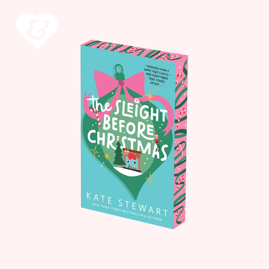 Book cover for 'The Slight Before Christmas' by Kate Stewart, featuring a turquoise and green holiday-themed design with pink accents, shown on a pale pink background.