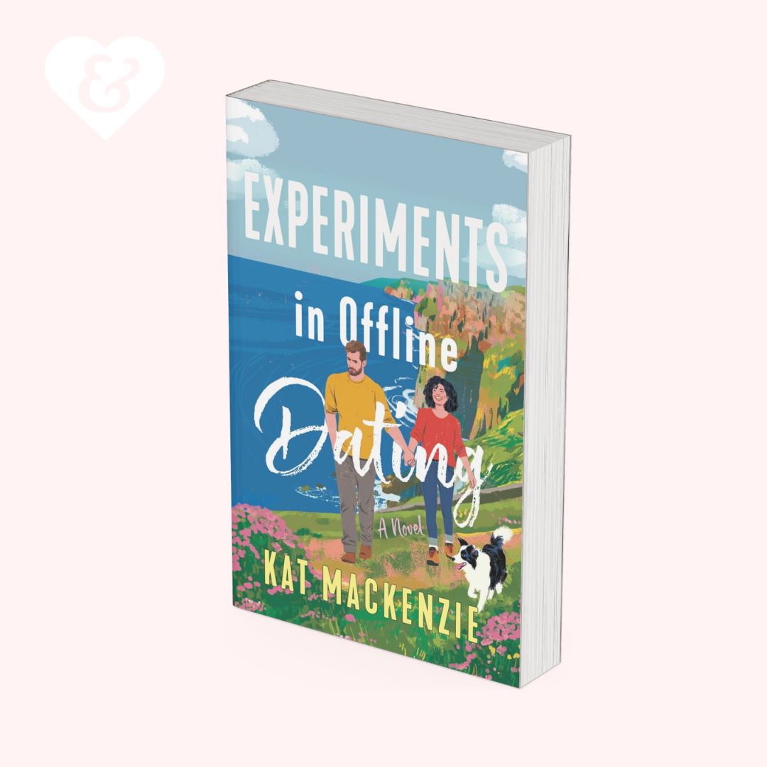 A 3D mockup of a paperback book titled 'Experiments in Offline Dating' by Kat Mackenzie, featuring a colorful illustrated cover with a couple and a dog against a light pink background.