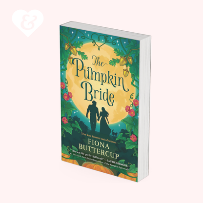 The book cover of 'The Pumpkin Bride' by Fiona Buttercup, shown as a 3D mockup on a pale pink background. The cover features a dark teal green background decorated with autumn vines, pumpkins, and a large yellow moon, with silhouettes of a bride and groom.