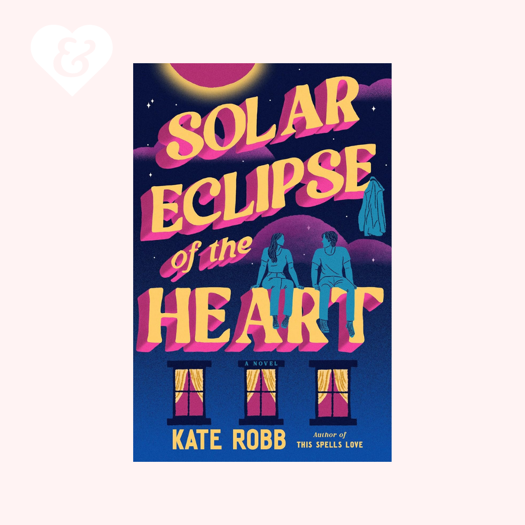 Book cover for 'Solar Eclipse of the Heart' by Kate Robb, featuring a dark blue night sky with a large pink and yellow moon, stylized pink and yellow title text, blue silhouettes of a couple, and three window illustrations at the bottom. The book is centered on a pale pink background with a small white heart-and-key icon in the top-left corner.
