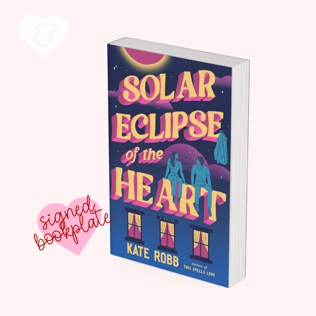 A 3D mockup of the book 'Solar Eclipse of the Heart' by Kate Robb, shown standing upright at an angle. The book cover features a dark blue background with a pink and yellow sun, stylized pink and yellow text, and blue silhouettes of figures in front of a building.