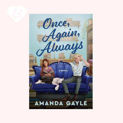 Book cover for the novel 'Once, Again, Always' by Amanda Gayle, featuring an illustrated scene of a man and woman sitting on a blue couch in front of a bookshelf, centered on a pale pink background.