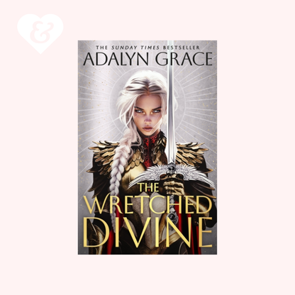 Book cover for 'The Wretched Divine' by Adalyn Grace, featuring a fantasy illustration of a woman with long white hair holding a sword, set against a pale pink background with a small heart-and-key mark in the top left corner.