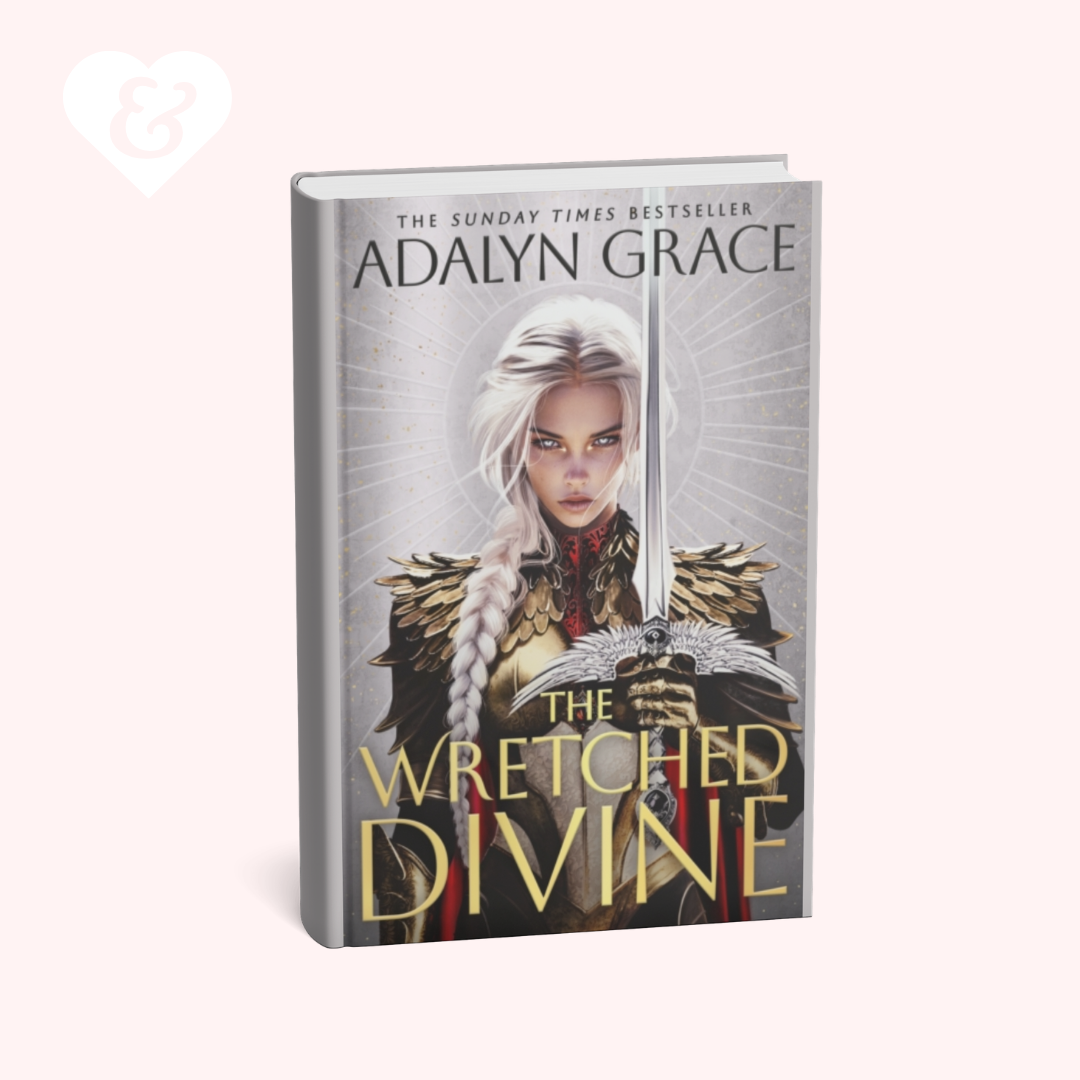 Book cover for 'The Wretched Divine' by Adalyn Grace, featuring a fantasy illustration of a woman with long white hair holding a sword, set against a pale pink background with a small heart-and-key mark in the top left corner.