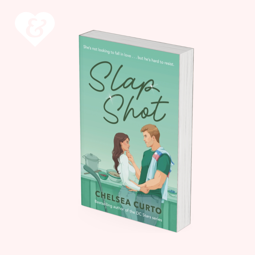 A 3D mockup of a paperback book titled 'Slap Shot' by Chelsea Curto, featuring a mint green cover with an illustration of a couple and black handwritten-style title text, set against a pale pink background.